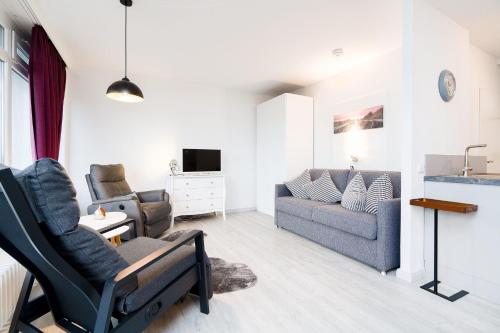 a living room with a couch and a chair at Baltic Whg 64 in Grömnitzerhagen