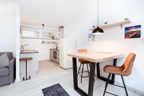 a kitchen and living room with a table and chairs at Baltic Whg 64 in Grömnitzerhagen