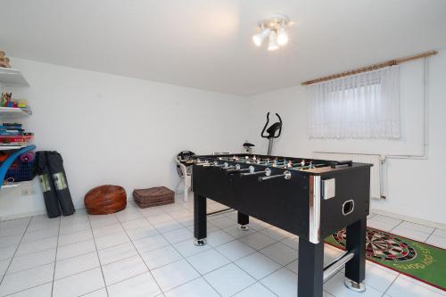 a room with a foosball table in the middle of a room at Fasaneneck 14a in Grömitz