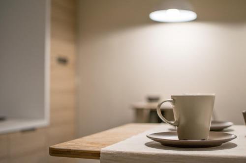 a coffee cup sitting on top of a kitchen counter at Namuri Rooms in Giardini Naxos
