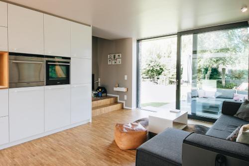 a living room with white cabinets and a couch at Ferienhaus Siegfried in Dierhagen