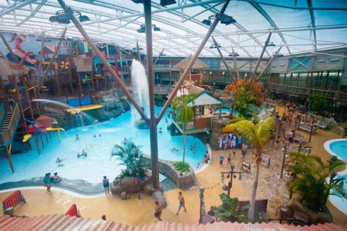 an indoor water park with a large swimming pool at Barn-Sleeps 4-Parking-Near Alton Towers Peak Dist in Waterfall
