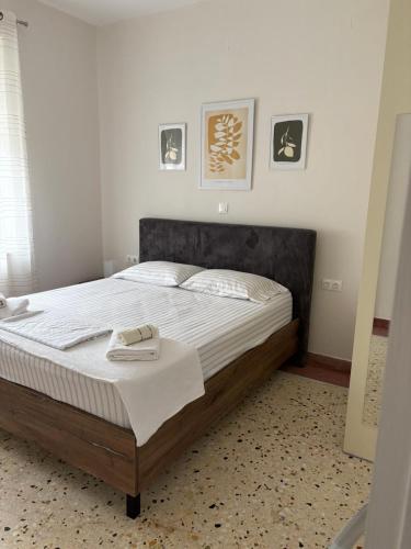 a bedroom with a large bed with a wooden frame at Katie's House in Sparta