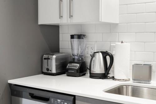 a kitchen counter with a blender and a sink at 4BR Corporate Suite Central and Modern in Chicago