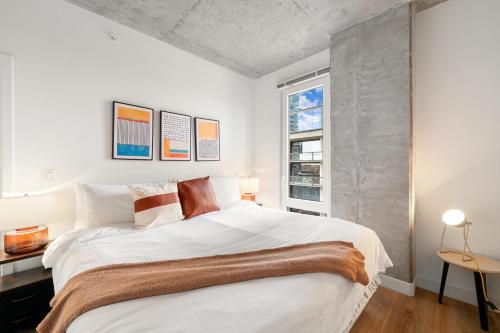 a bedroom with a large white bed and a window at 4BR Corporate Suite Central and Modern in Chicago