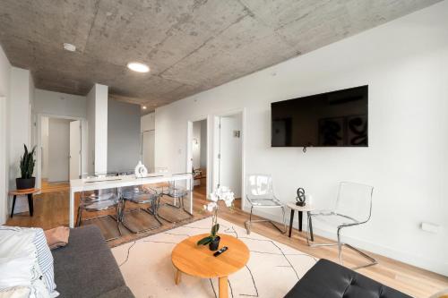 a living room with a couch and a table at 4BR Corporate Suite Central and Modern in Chicago