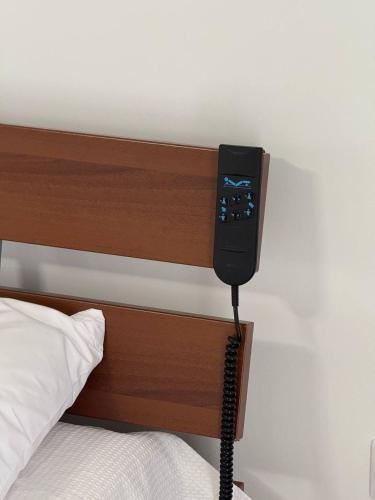 a phone is attached to the side of a bed at Panorama Apartment in Kavála