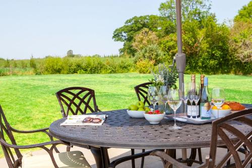 a table with wine glasses and fruit on it at Marrington Farmhouse in Chirbury