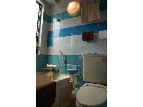 a bathroom with a toilet and a bath tub at Business Hotel Crescent - Vacation STAY 49938v in Tokyo