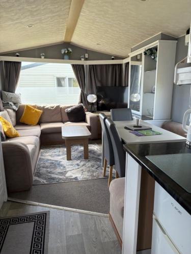 an rv living room with a couch and a table at Roseanna in Kingsnorth