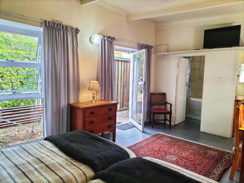 a bedroom with a bed and a tv and a window at Suites on 74 in Worcester