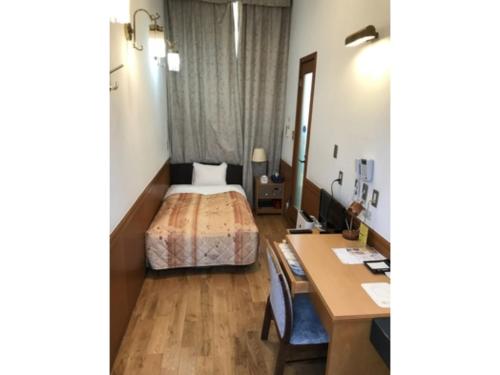 a hotel room with a bed and a desk at Business Hotel Crescent - Vacation STAY 49930v in Tokyo