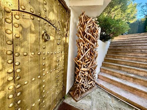 a wooden door with a pile of wood next to a staircase at Aya House in Barcelona