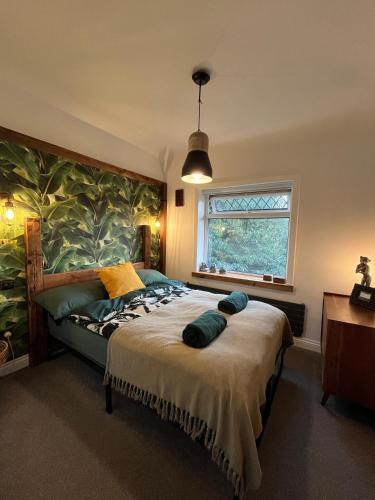 a bedroom with a large bed and a window at Luxury Oriental Home with Exotic Garden & Free Parking in West Derby