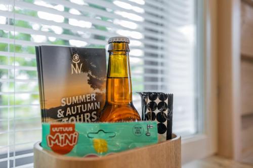 a container with a bottle of beer and a box of snacks at Elves Eco Design House B in Rovaniemi