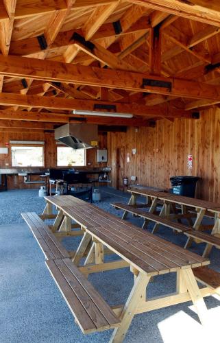 a large wooden picnic table in a barn at Glentanner Park Centre in Glentanner