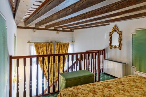 a bedroom with a bed and a balcony at Hotel Giorgione in Venice