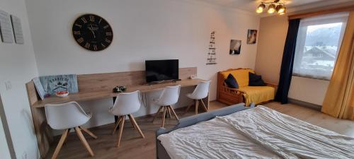 a bedroom with a bed and a desk with chairs at Mountain view apartments in Bad Mitterndorf