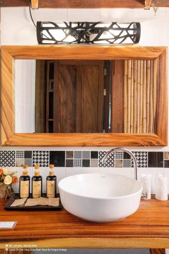 a bathroom with a sink and a mirror at Tongna Cottage Natural Resort in Chiang Mai