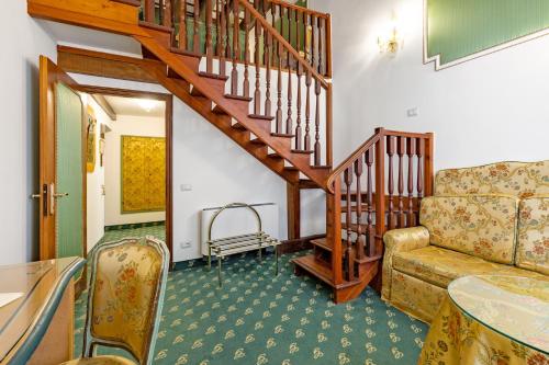 a living room with a couch and a staircase at Hotel Giorgione in Venice