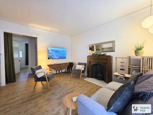 a living room with a couch and a fireplace at High Street Stay - Oban in Oban