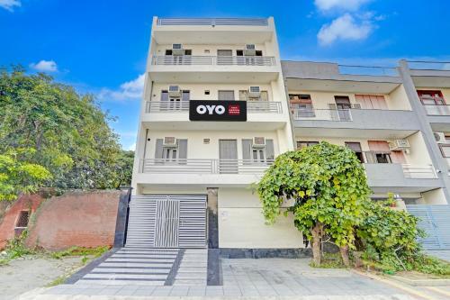 a white building with a ovo sign on it at Jagdamba Homestay in Greater Noida