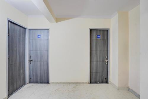 three metal doors in a room with a white wall at Jagdamba Homestay in Greater Noida