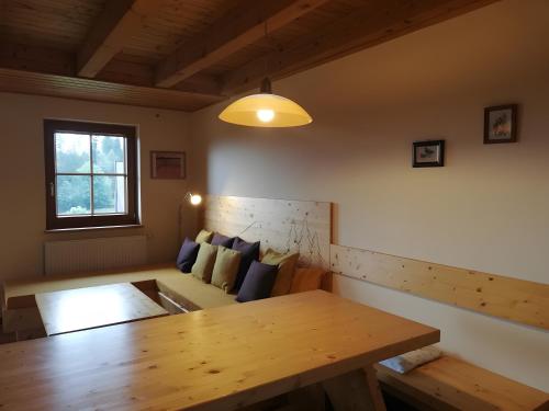 a living room with a wooden table and a couch at Sigmundenhof Schonach in Schonach