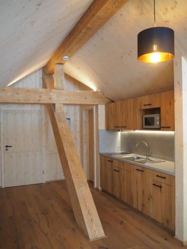 a kitchen with a wooden ceiling and a sink at Sigmundenhof Schonach in Schonach
