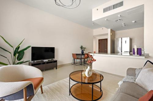 a living room with a couch and a table at Silkhaus Premier 2BR Apartment in Marina Bay in Mushayrib