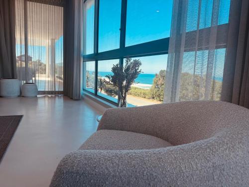 a living room with a couch and a view of the ocean at Salt and Sand in Wilderness