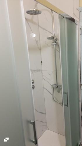 a bathroom with a shower with a glass door at Hotel Conchiglia in Montecatini Terme