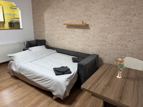 a bedroom with a bed and a coffee table at Small apartment in Hunedoara in Hunedoara