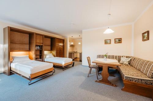 a hotel room with a bed and a couch at Ferienwohnungen Biermeier in Bad Birnbach
