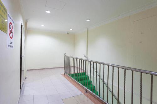an empty hallway with a staircase in a building at T P Hotel in Sitiawan
