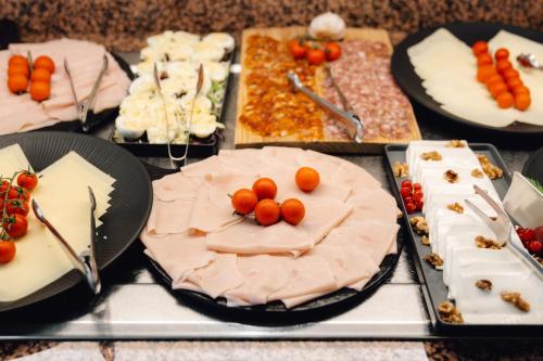a table with many different types of cakes and desserts at Hotel Moon Dreams Paraiso - Adults Recommended in Es Cana