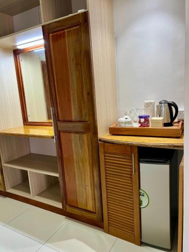 a kitchen with a wooden cabinet and a mirror at Villa Chez Batista in Takamaka