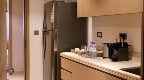 a kitchen with a stainless steel refrigerator at InterContinental Fujairah Resort by IHG in Al Aqah