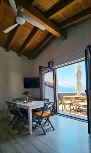 a dining room with a table and chairs and a balcony at REST AND VIEW APARTMENT in Vercana
