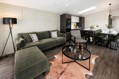 a living room with a couch and a table at Sunniva Lodge in Malton