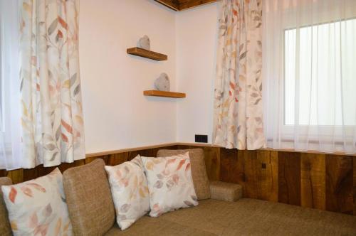 a living room with a couch and a window at Ferienwohnung Rohrmoser mit 2 Schlafzimmern in Hüttschlag