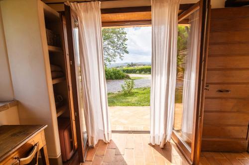 a door to a kitchen with a view of a yard at Agriturismo Sole in Trequanda