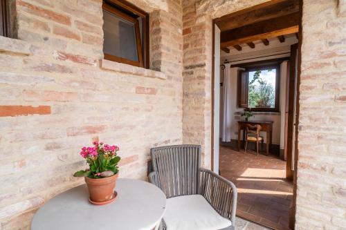 a table and two chairs and a table with flowers on it at Agriturismo Sole in Trequanda