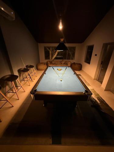 a ping pong table in a room with some chairs at Sandalu Bungalows unit1 in Hambantota