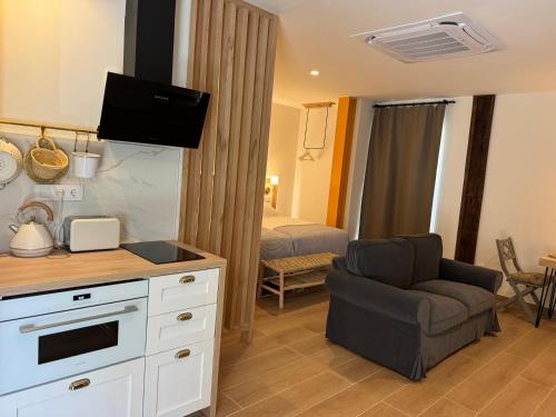 a living room with a couch and a chair in a room at Arenas Suites in Potes