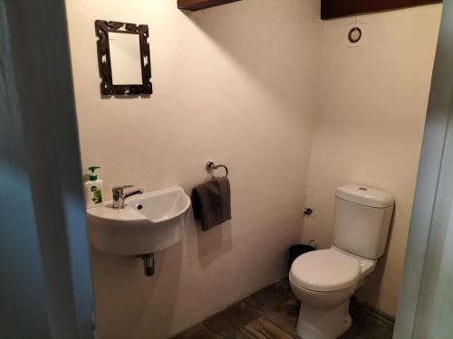 a bathroom with a toilet and a sink at Suites on 74 in Worcester