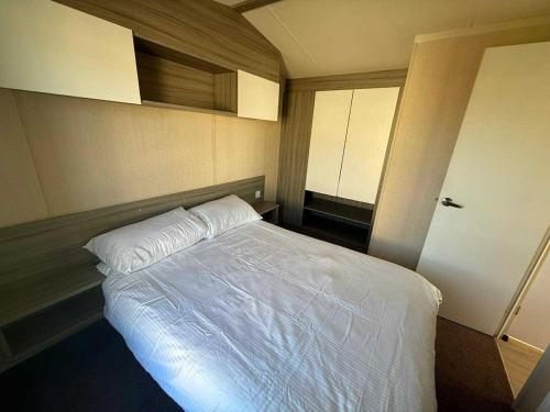 a bedroom with a large white bed in it at Salty Breezes in Ingoldmells