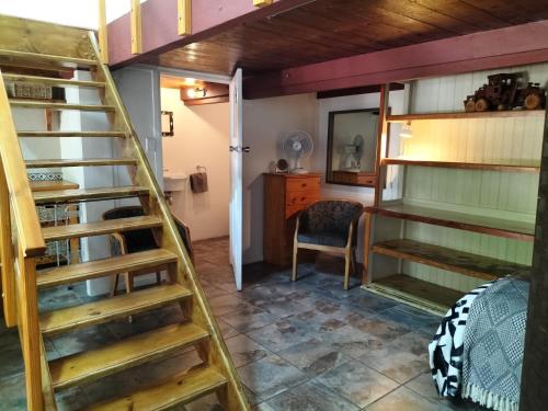 a room with a ladder leading to a bedroom at Suites on 74 in Worcester