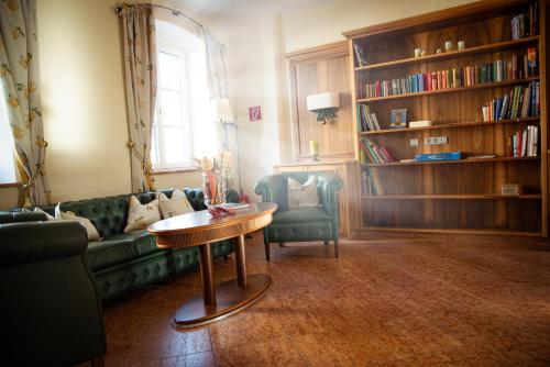 a living room with a couch and a table at Landgasthof Winter in Ardagger Stift