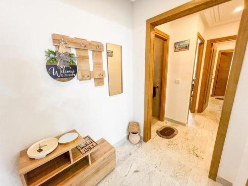 a room with a table and a sign on the wall at Amazing 2BR Apartment in Tunis in Tunis